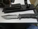 (1) USED MACHETE IN BLACK SHEATH; (1) USED SOG KNIFE IN BLACK SHEATH; (1) USED LEATHER HOLSTER; (1) USED CAMO HOLSTER