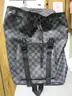 (1) LIKE-NEW BLACK AND GRAY CHECKERED BACKPACK