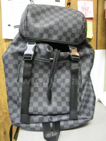 (1) LIKE-NEW BLACK AND GRAY CHECKERED BACKPACK