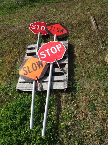 (4) USED TRAFFIC STOP/SLOW SIGNS