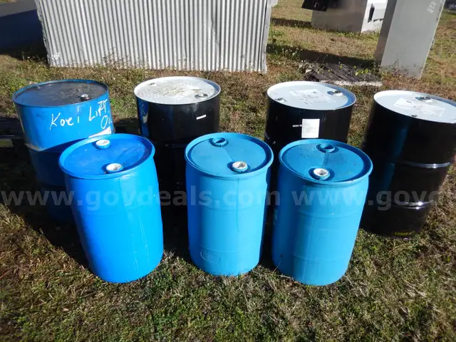 USED (3) 55 GALLON BLACK METAL DRUMS, (1) 55 GALLON BLUE METAL DRUM, (3) 30 GALLONBLUE PLASTIC DRUMS