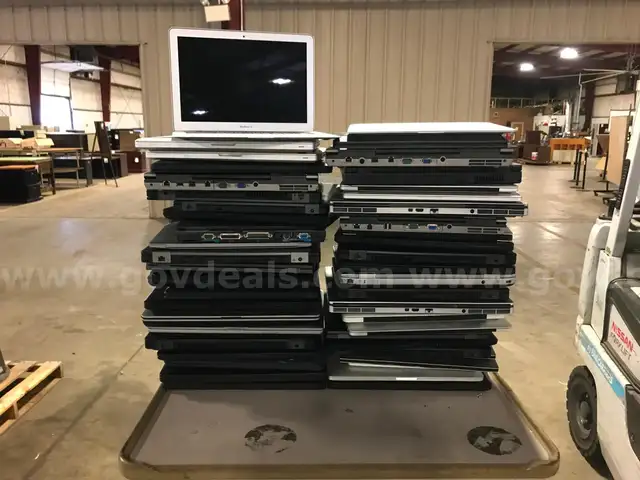 LOT OF LAPTOPS, ALL IN ONES, MONITORS AND MISC. ITEMS ON THREE PALLETS.