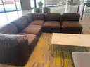 brown sectional couch with marble coffee table and gray chair
