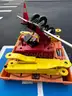 Red tool dolly and two bright yellow lift attachments