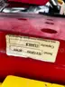 Red tool dolly and two bright yellow lift attachments