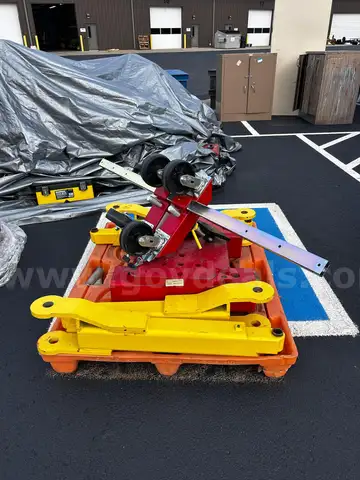 Red tool dolly and two bright yellow lift attachments