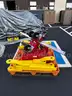 Red tool dolly and two bright yellow lift attachments