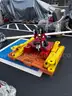 Red tool dolly and two bright yellow lift attachments