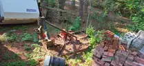 assortment of old bush hogs and trailers