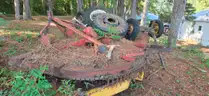 assortment of old bush hogs and trailers