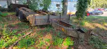 assortment of old bush hogs and trailers