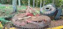 assortment of old bush hogs and trailers