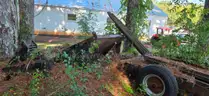 assortment of old bush hogs and trailers