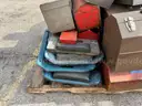 Lot of old toolboxes, under-vehicle creepers, retractable fluorescent lights, and a metal desk
