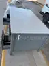 Lot of old toolboxes, under-vehicle creepers, retractable fluorescent lights, and a metal desk
