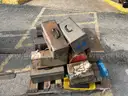 Lot of old toolboxes, under-vehicle creepers, retractable fluorescent lights, and a metal desk