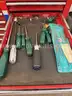 Metal rolling toolbox containing various tools
