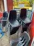 Lot of black, plastic, stackable chairs.