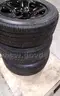 Lot of (4) Firestone Fire-Hawk Pursuit tires (275/55R20 113V M&#x26;S) mounted on Chevrolet 6 bolt stock black rims.