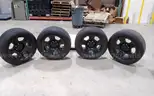 Lot of (4) Firestone Fire-Hawk Pursuit tires (275/55R20 113V M&#x26;S) mounted on Chevrolet 6 bolt stock black rims.