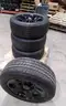 Lot of (4) Firestone Fire-Hawk Pursuit tires (275/55R20 113V M&#x26;S) mounted on Chevrolet 6 bolt stock black rims.
