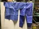 Pallet of Disposable Chemotherapy Gowns and Scrub Tops and Bottoms.