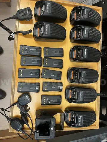 Eight Motorola Impres WPLN4114AR battery chargers with additional accessories
