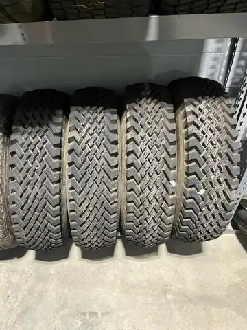 Set of four Skid Steer tires on rims