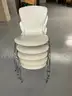 5 white Stack Chairs