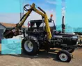 Ford tractor with alamo slope mower attached