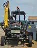 Ford tractor with alamo slope mower attached