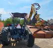 Ford tractor with alamo slope mower attached