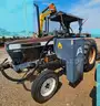 Ford tractor with alamo slope mower attached