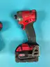 2 - Milwaukee Cordless 1/4" Impact Drivers with Batteries, Both Power On