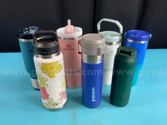 7 - Water Bottles, Labeled as: 5 - Stanley, 1 - Starbucks & 1 - YETI