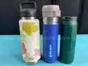 7 - Water Bottles, Labeled as: 5 - Stanley, 1 - Starbucks & 1 - YETI