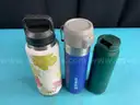 7 - Water Bottles, Labeled as: 5 - Stanley, 1 - Starbucks & 1 - YETI