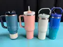 7 - Water Bottles, Labeled as: 5 - Stanley, 1 - Starbucks & 1 - YETI