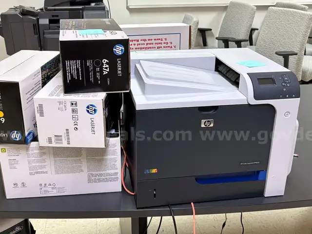 HP Color LaserJet CP4025 Printer with various toner cartridges
