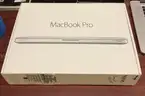 A MacBook Pro With Charger and Box