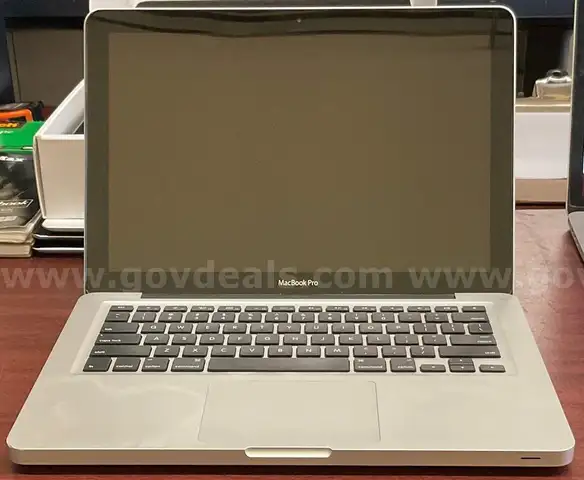 A MacBook Pro With Charger and Box