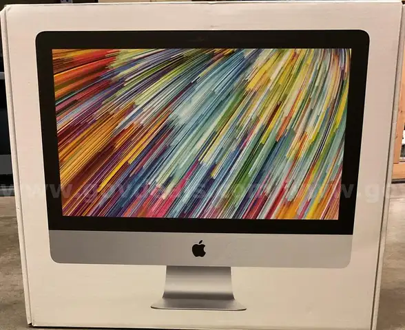 An iMac with Power Cord and Box