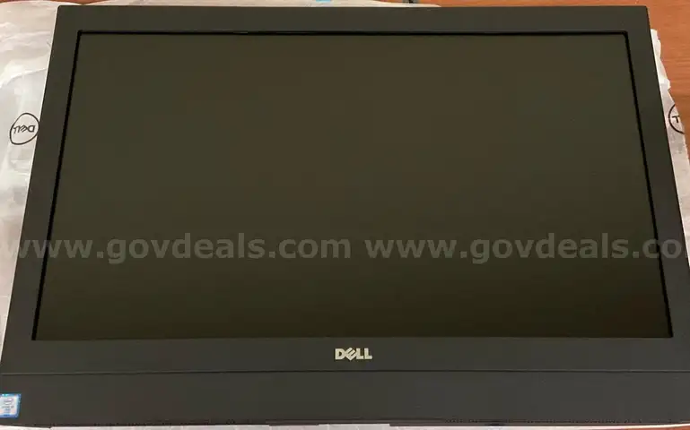 An Optiplex 7450 All-in-One with Power Cord and Box
