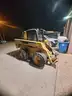 2007 John Deere 328 w/4 way bucket and asphalt grinder