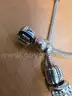 Silver tone bracelets (2) with charms
