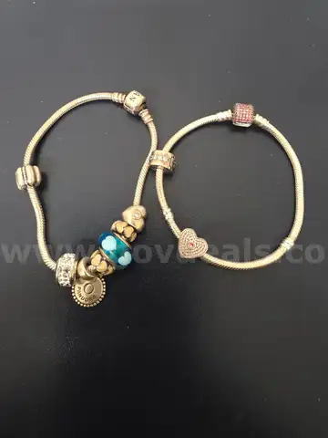 Silver tone bracelets (2) with charms